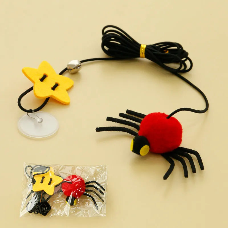 Red and yellow hanging door cat toy with feather, bell, spider, and elastic rope for interactive pet play