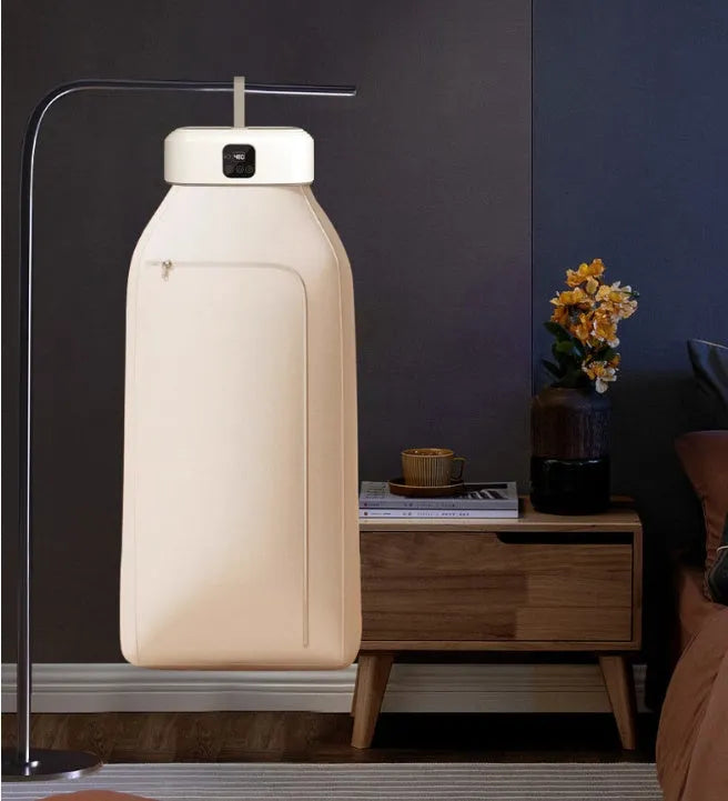 White cylindrical foldable electric clothes dryer with remote control, shown in open position