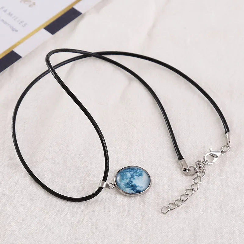 Luminous alloy necklace with a glass pendant depicting a Christmas moon night sky, showing the extension chain.
