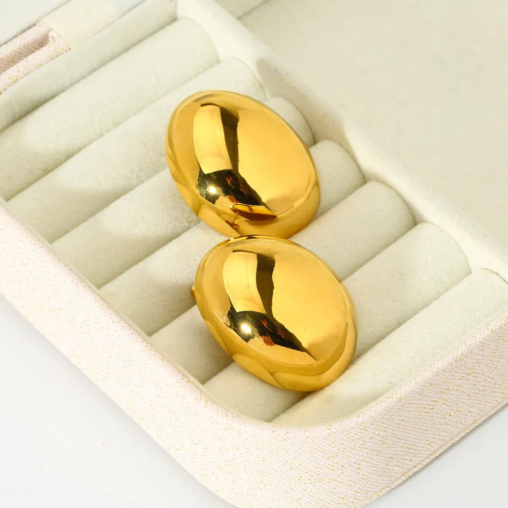 A pair of geometric line design ear studs with a high-shine glazed silver finish.