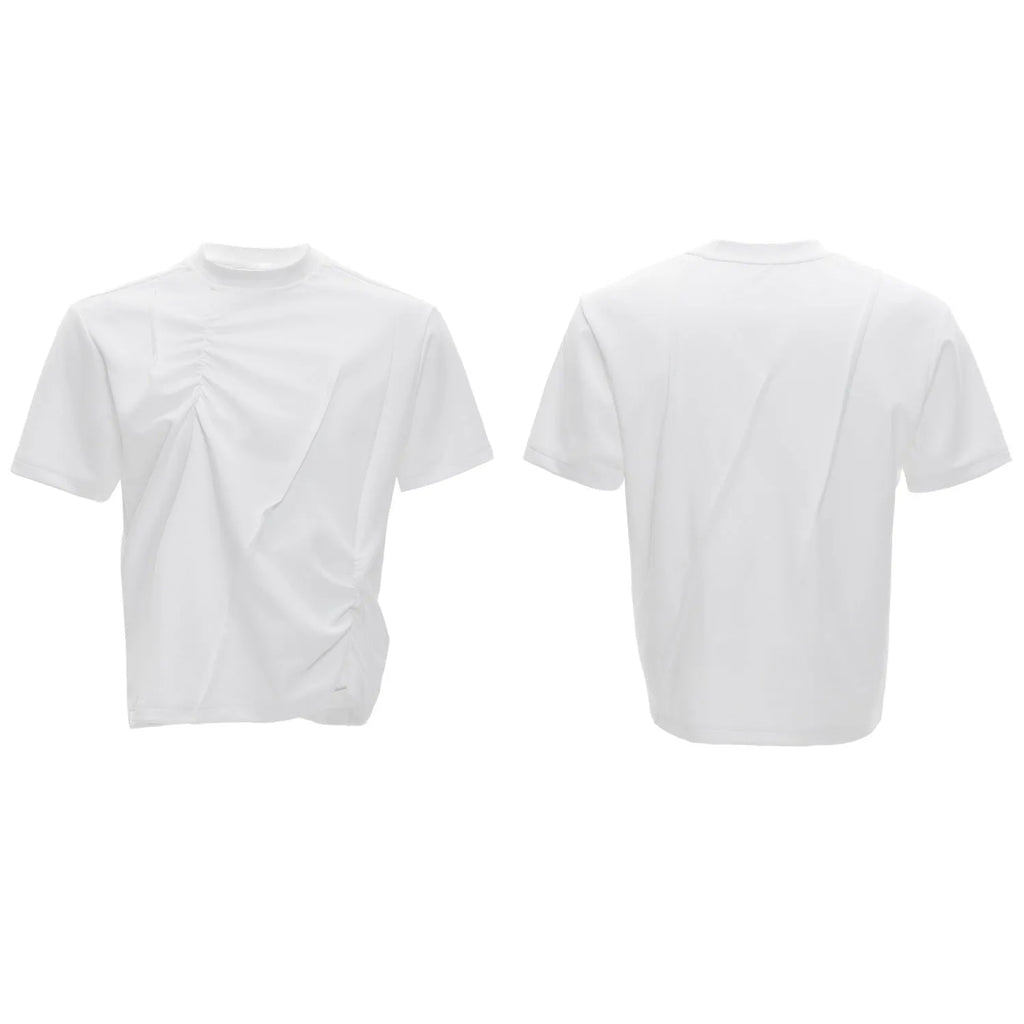 Man wearing a loose grey cotton T-shirt with three-dimensional pleated detailing on the front.