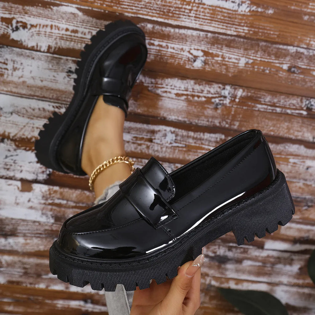 Plus size women's black chunky heel loafers with a slip-on mid-top design and rubber sole.