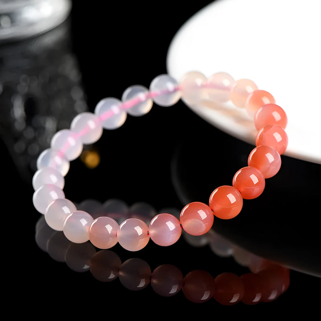 Natural gradient Yanyuan agate bracelet with geometric polished beads on a wrist, showing salt source colour variation.