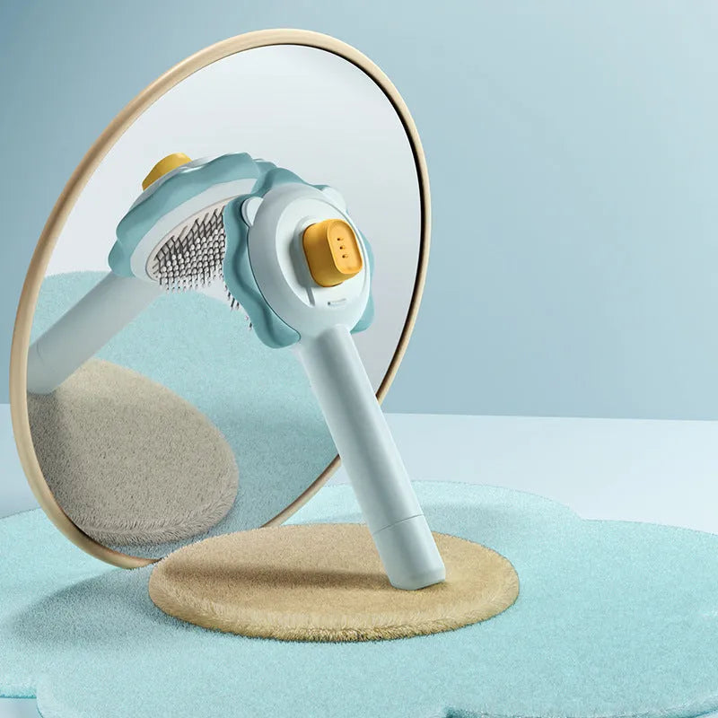 Stainless steel pet comb with one-click hair removal in blue, pink, and yellow colours on white background