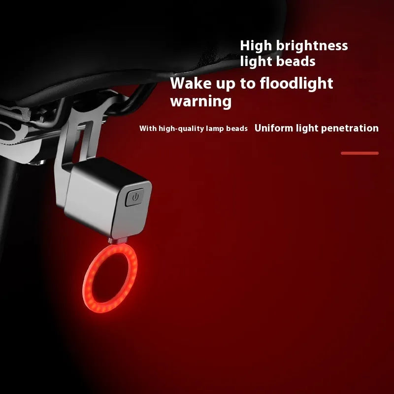 USB rechargeable bicycle running water tail light with silicone strap mount on a bike seat tube.