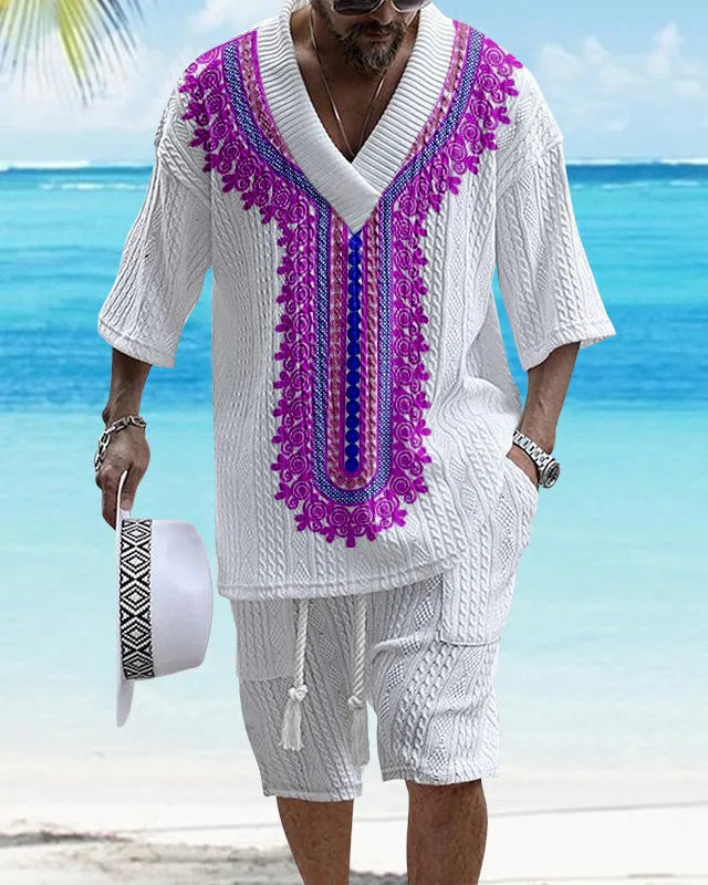 Man wearing a printed drop-shoulder knitted top and matching shorts from a two-piece lounge suit.