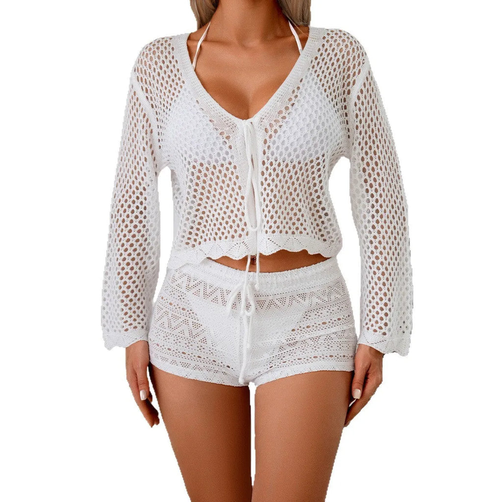 Short apricot coloured women's cardigan blouse with long bell sleeves on a hanger.