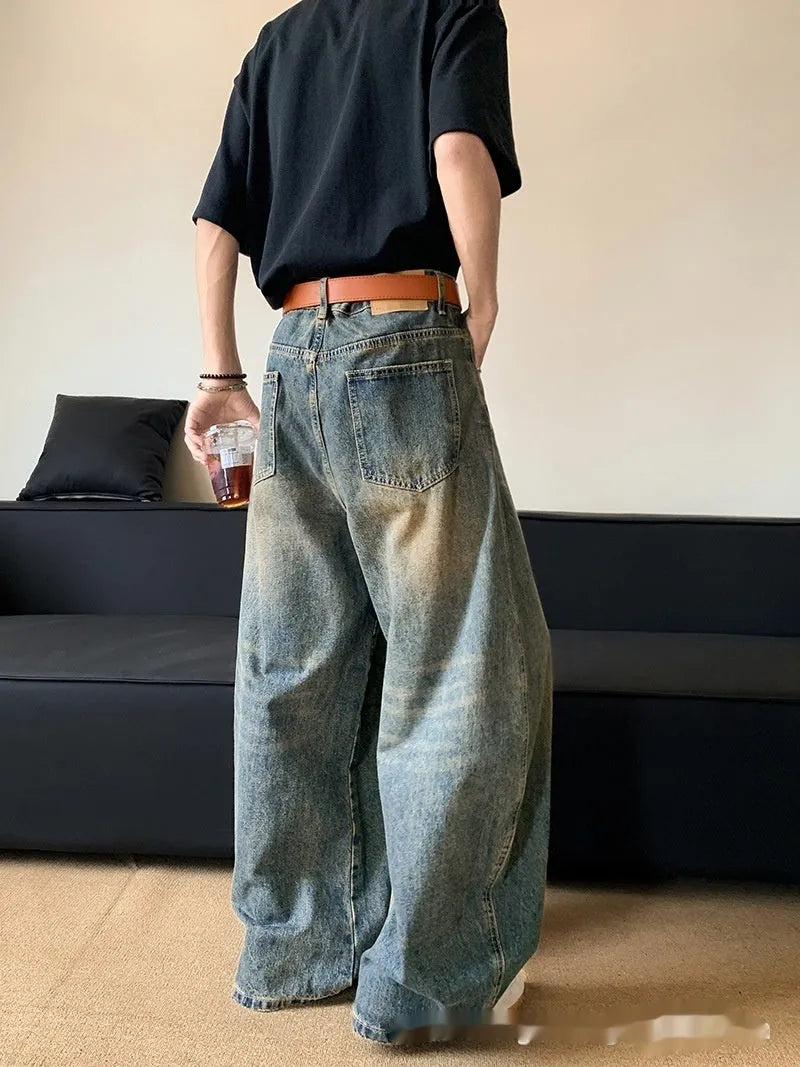 Men's retro blue distressed denim jeans with slim wide-leg fit showing micro elasticity fabric