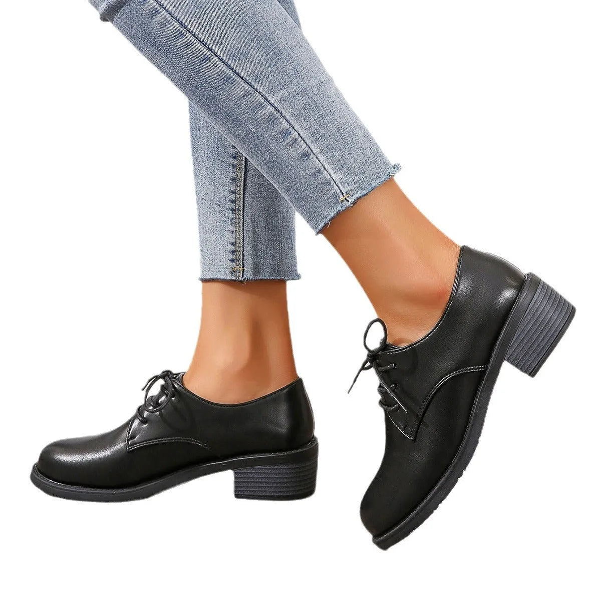 Black women's low top work shoes with a short chunky heel and pointed toe.