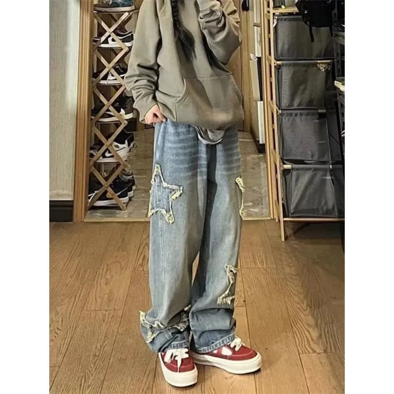 Blue high waist wide-leg denim trousers on a hanger, showing straight leg cut.
