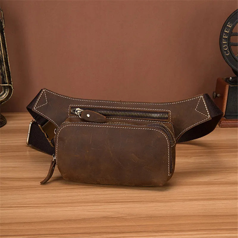 Brown cowhide leather men's sports waist bag with zip, shown with phone in internal pocket.