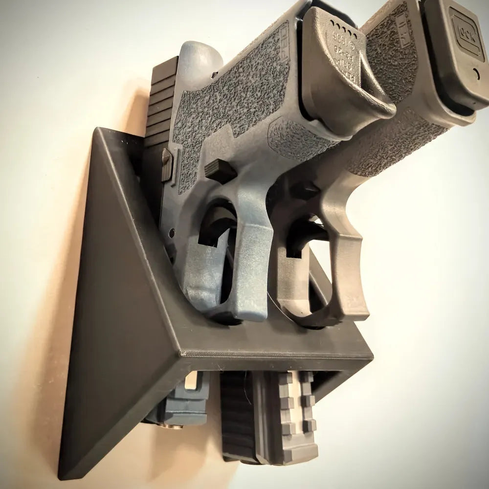 Black punk-style plastic pistol stand measuring 10.85 by 7.6 centimetres