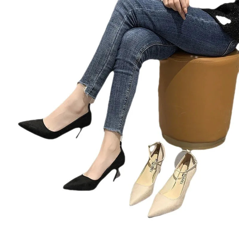 Women's black stiletto pump shoes with a buckle decoration on the upper