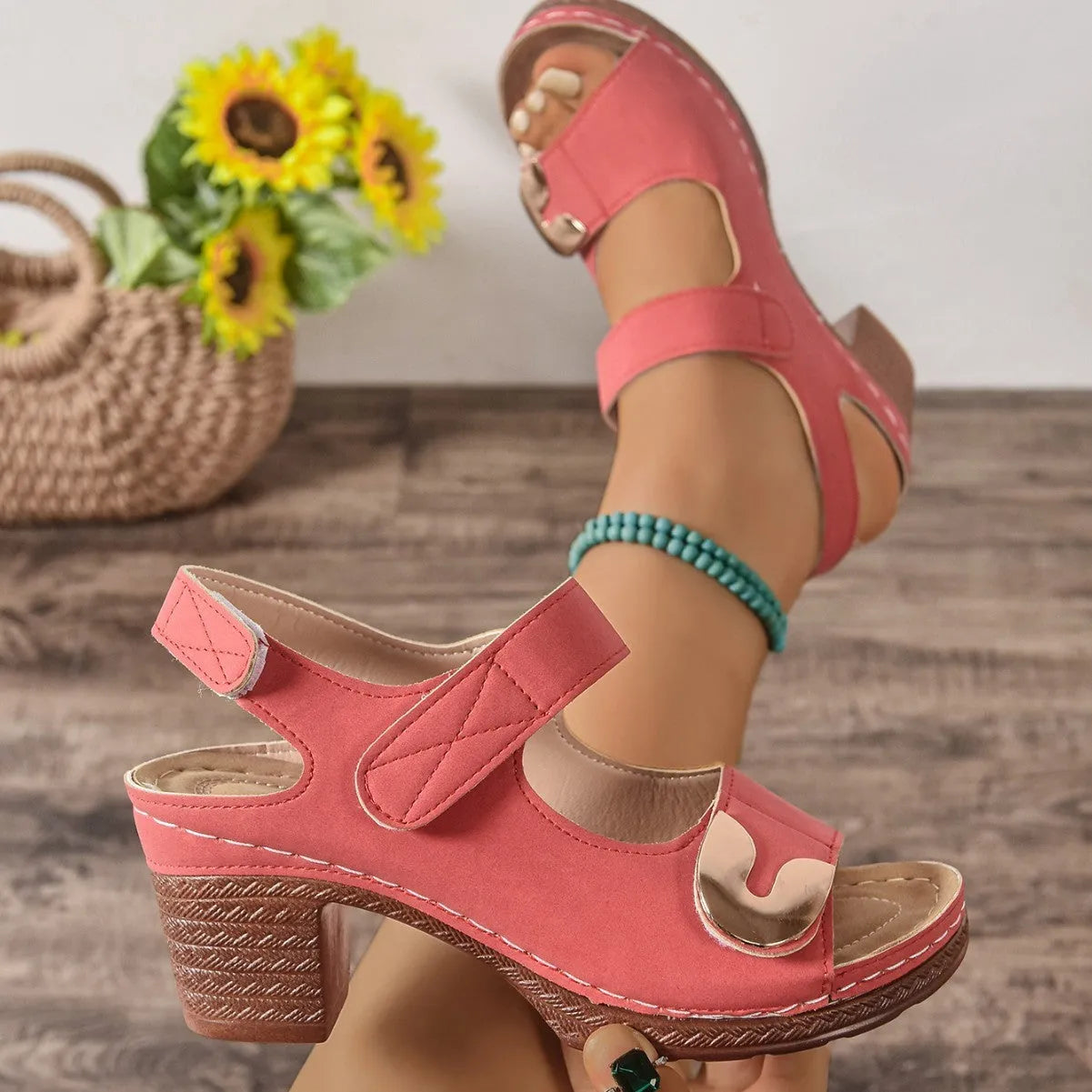 A pair of light brown Roman-style sandals with a round toe and a single Velcro closure strap.