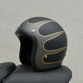 Glass fibre retro half motorcycle helmet shown in various colours including cement gray and matte black options