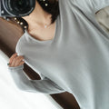 Women's V-neck long sleeve knit pullover top in a macaron colour on a hanger.
