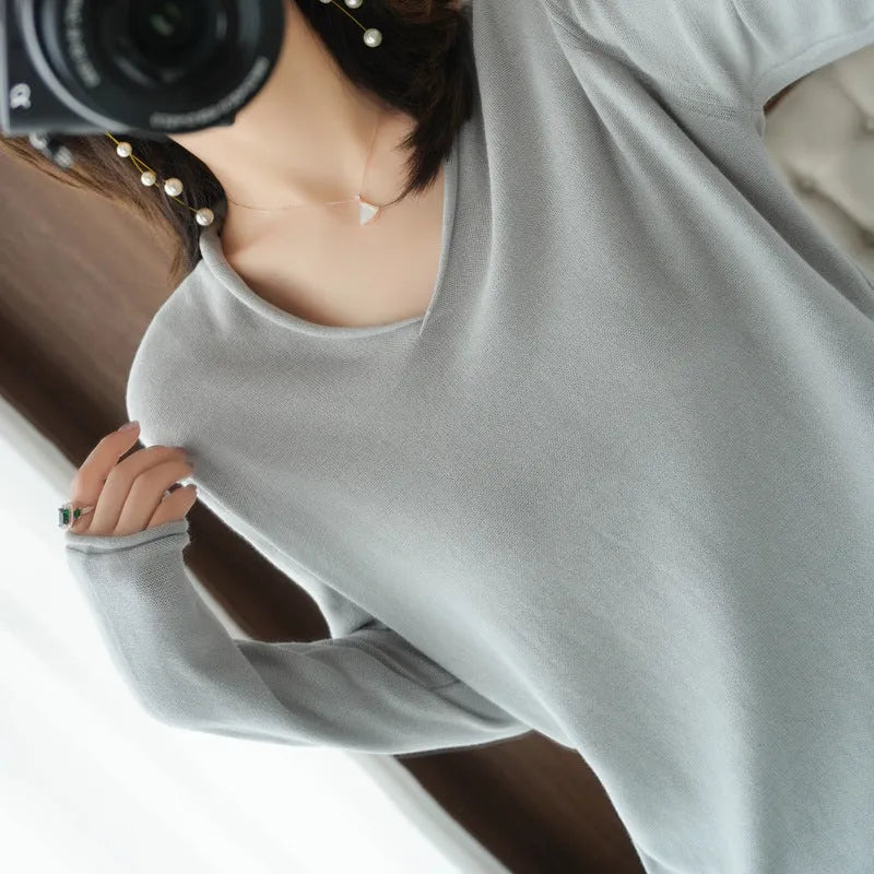 Women's V-neck long sleeve knit pullover top in a macaron colour on a hanger.