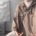 A man wearing a loose grey hooded short sleeve t-shirt on a casual day.