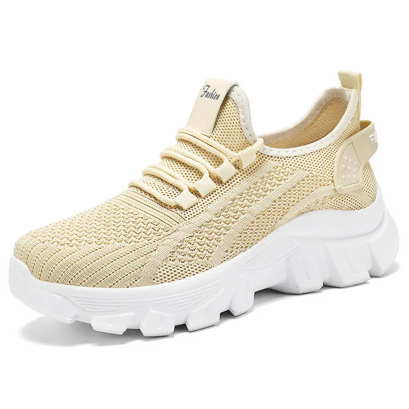 Women's white Flyknit lace-up sneakers with a thick PVC sole and round toe on a neutral background