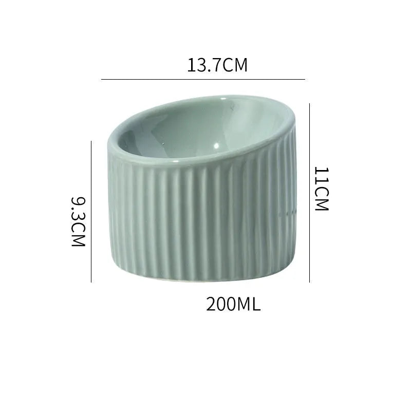 Round ceramic elevated cat bowl in green colour on a table