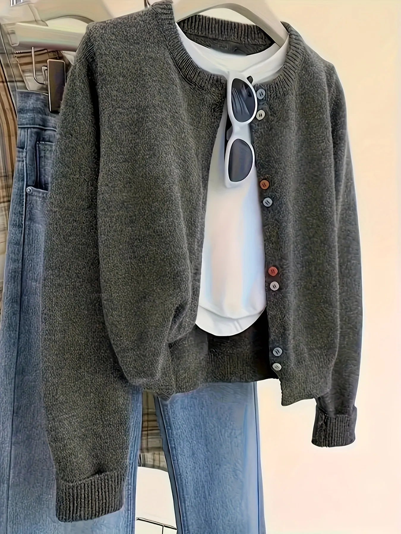 Dark grey women's polyester cardigan with buttons and long sleeves on a hanger