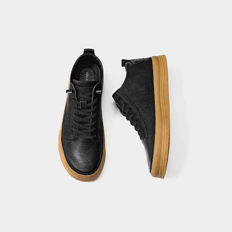 Men's black casual leather shoes with round toe, flat heel, and lace closure on a white background