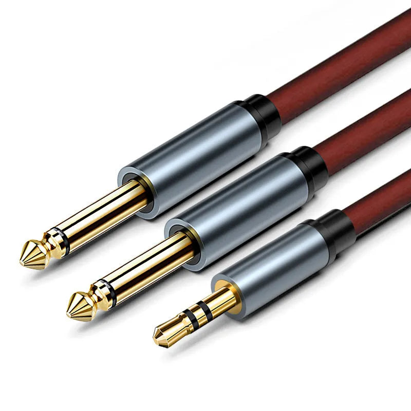 3.5mm stereo to two 6.5mm male audio cable with gold-plated connectors on a black background