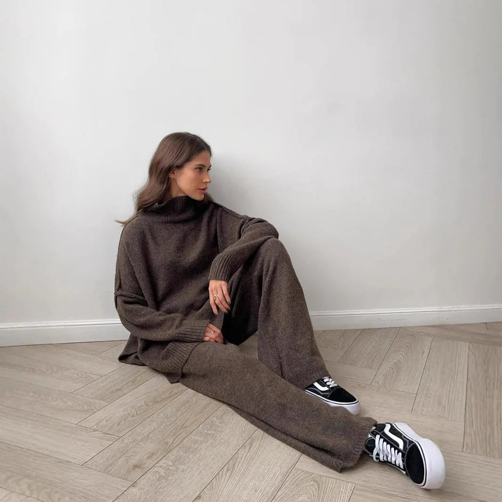 Women's acrylic sweater suit with side-slit top and trousers in dark grey.