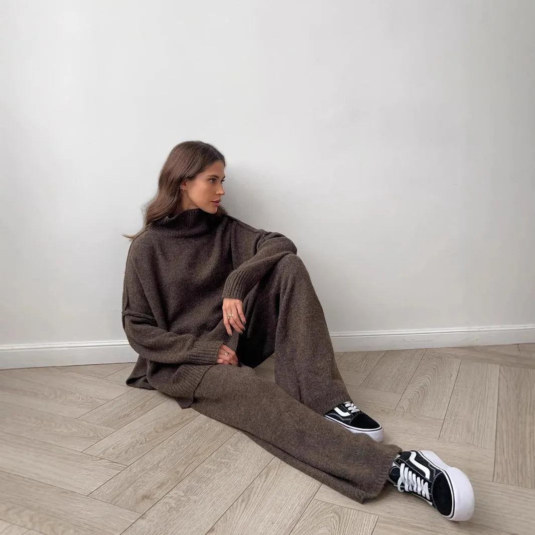 Women's acrylic sweater suit with side-slit top and trousers in dark grey.