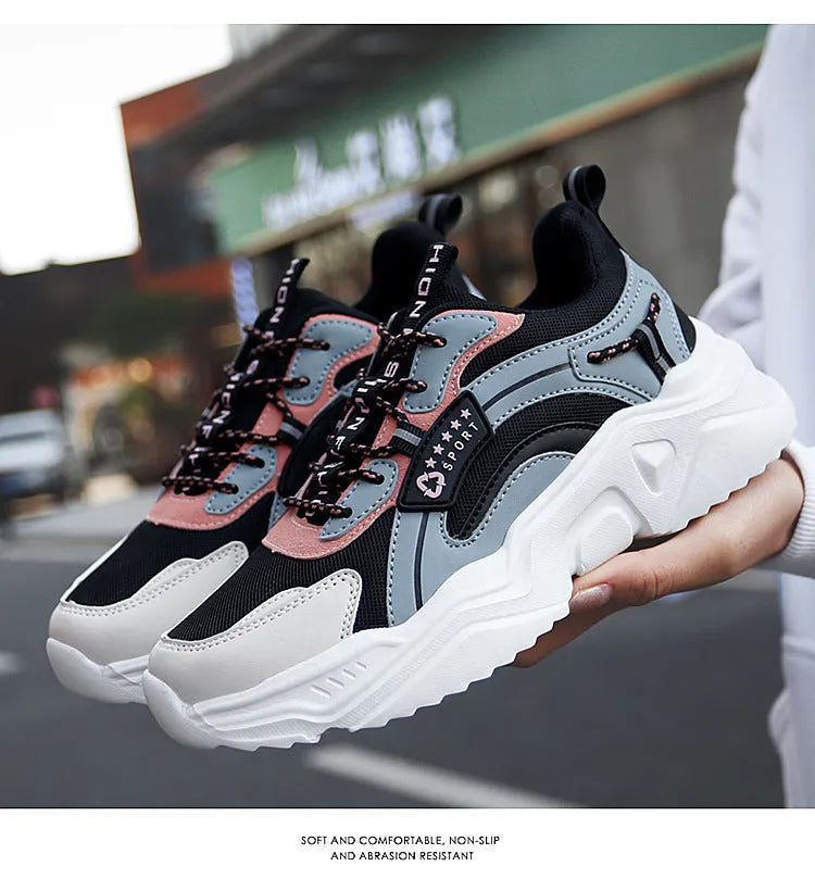 White women's casual mesh sports shoe with thick sole, buckle detail, and round toe.