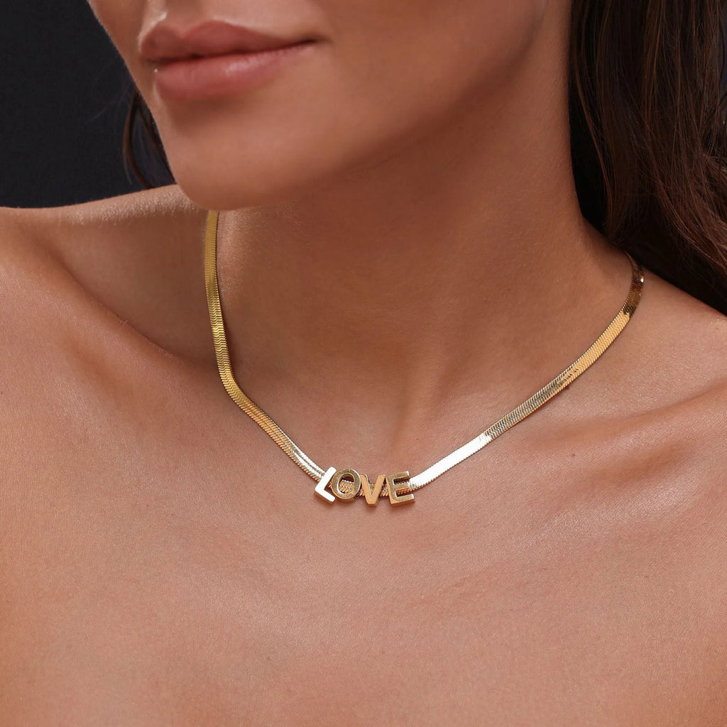 Titanium steel necklace with a choice of letter, number, or love heart pendant on a 40.5 cm chain.