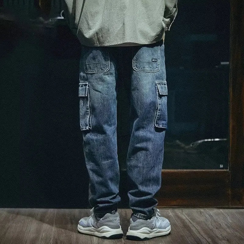 Men's blue loose straight retro style polyester denim trousers on a neutral background.