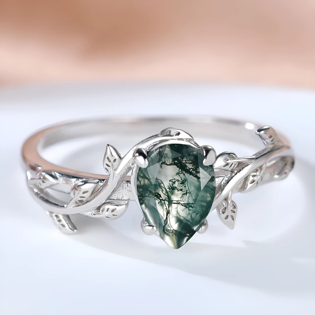 S925 silver drop-shaped agate edge branch leaf ring on white background, sterling silver band with natural stone