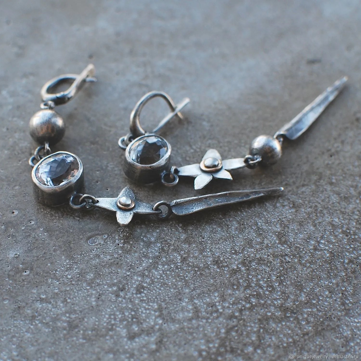 Geometric long pendant earrings with rhinestone drops in antique silver finish.