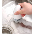 Carrot-shaped nylon kitchen cleaning brush in orange colour, 14.5cm length