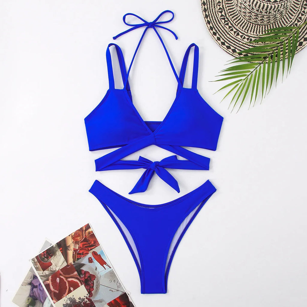 Women's solid colour strappy bikini swimsuit in black, blue, red, rose red, or white on a mannequin.