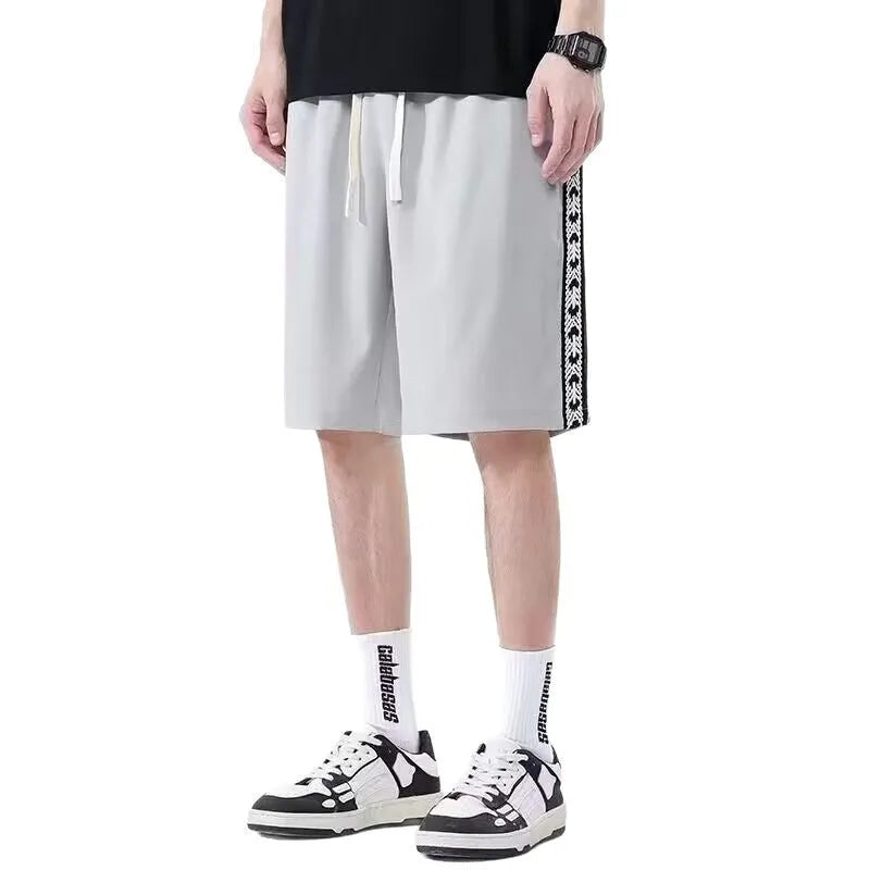 Men's black baggy track pants with micro elasticity showing loose fit sports style