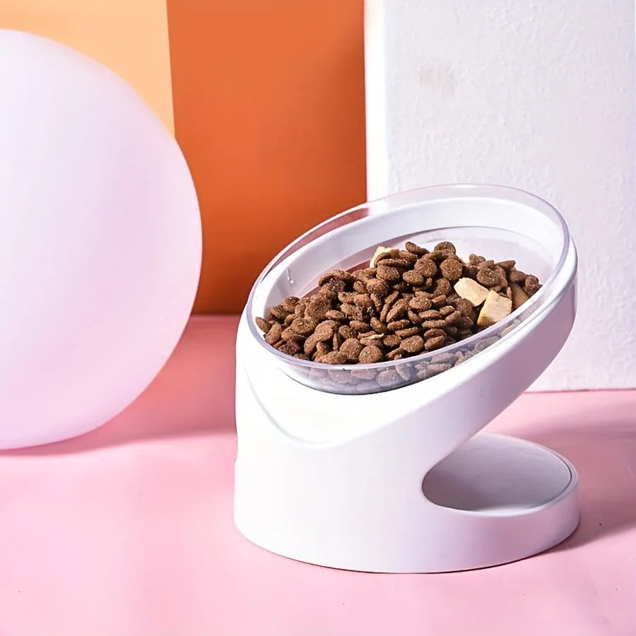 White elevated tilted plastic cat food bowl on a flat surface