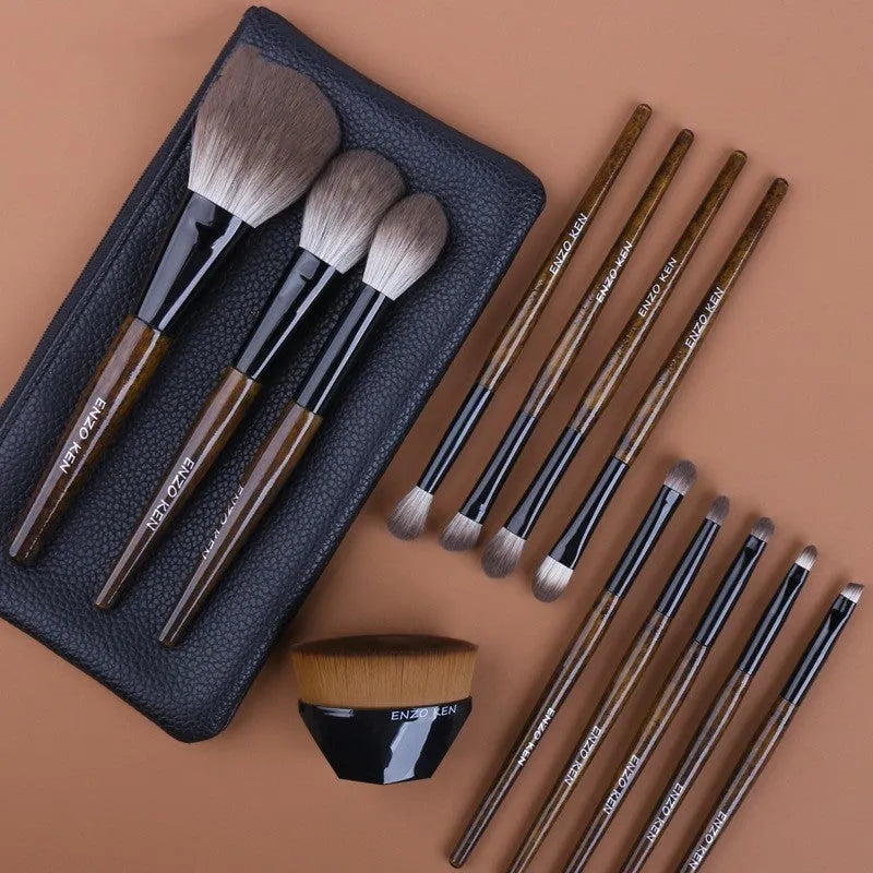 12-piece makeup brush set with wooden handles and a grey PU storage pouch.