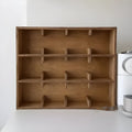 Square solid wood storage rack with multiple grid compartments for cups and mugs in a birch wood finish.