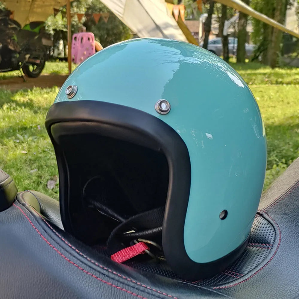 Glass fibre retro half motorcycle helmet shown in various colours including cement gray and matte black options