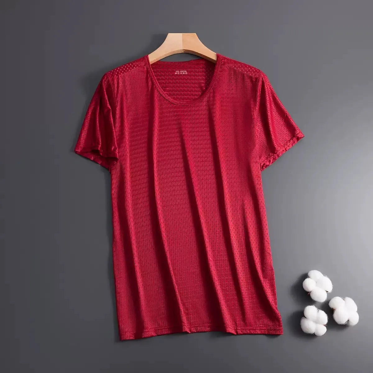 Man wearing a solid colour ice silk short sleeve crew neck T-shirt in a loose fit.