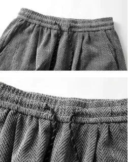 Light gray fleece-lined straight-leg trousers with a hollow-out design on a hanger.