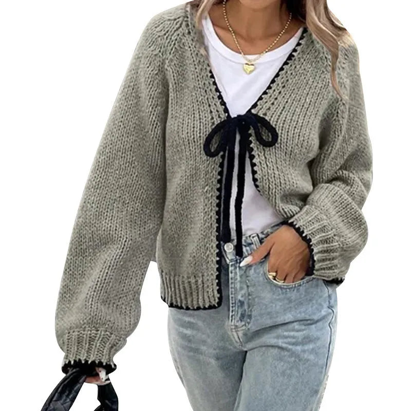 Grey lace-up sweater cardigan with long sleeves and crocheted flower decoration on the front.