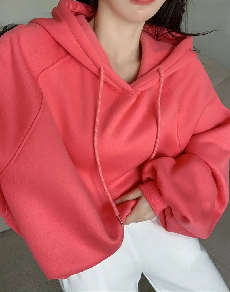 Women's watermelon red sleeveless hooded sweater made from mulberry silk fabric on a hanger