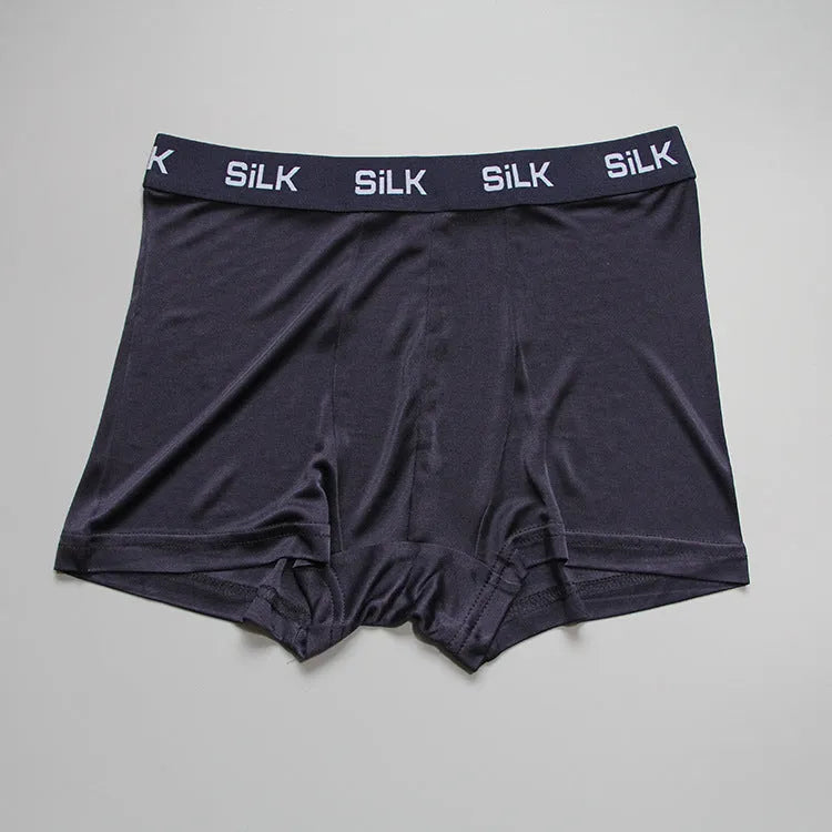 Men's loose-fit silk shorts in navy blue, shown laid flat.