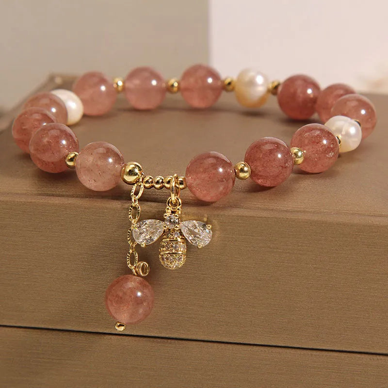 Women's bracelet with strawberry quartz stones, freshwater pearls, and zircon accents on an alloy chain.
