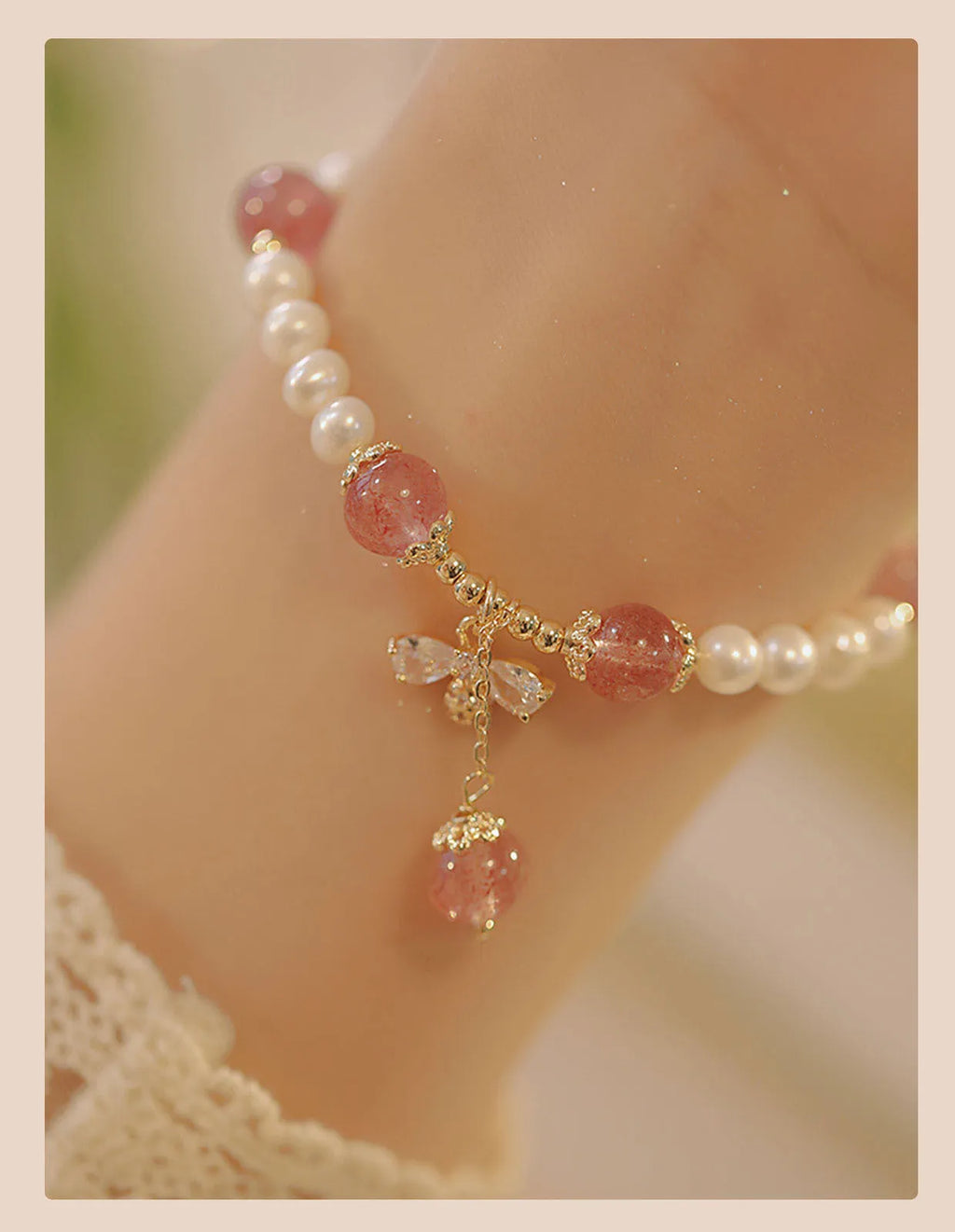 Women's hand-made strawberry quartz crystal bracelet with stringed pearls and bow detail
