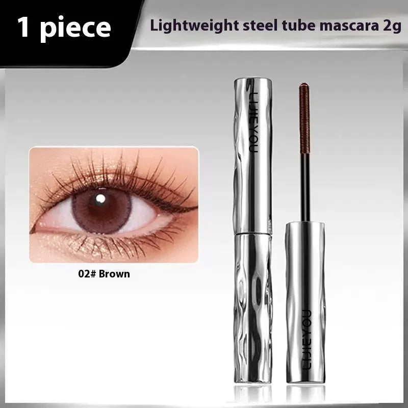 Waterproof black and brown steel tube mascara with optional eyelash curler accessory.