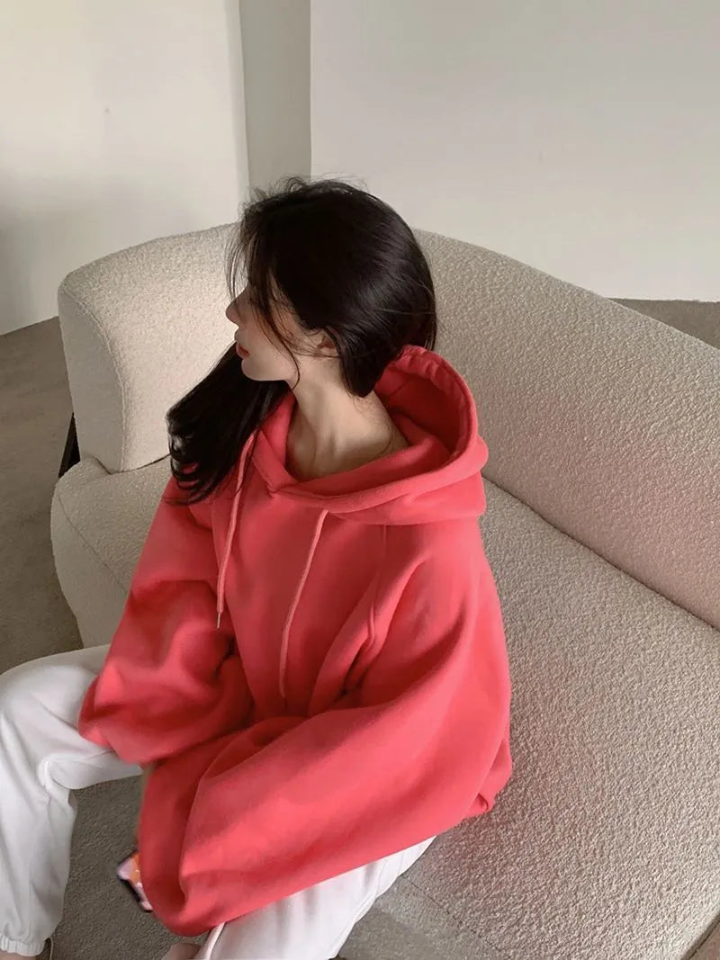 Women's watermelon red sleeveless hooded sweater made from mulberry silk fabric on a hanger
